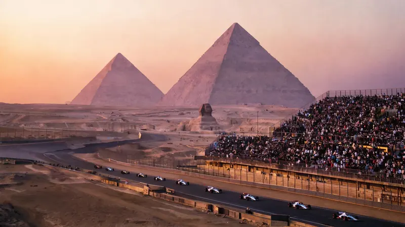 FLUX 3 Klein example: Formula 1 cars racing past a packed grandstand at dusk, the Sphinx and the pyramids of Giza behind them.