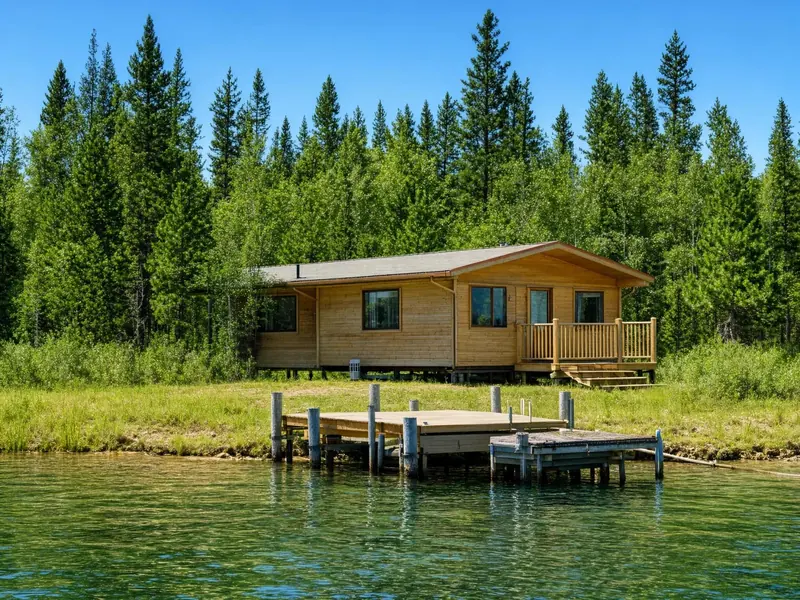 Make it a winter night: snow on the roof, the dock and the trees, the lake is fr: input 1