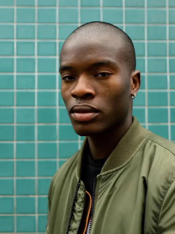 FLUX 3 Klein example: Portrait of a young man in an olive bomber against teal tiles