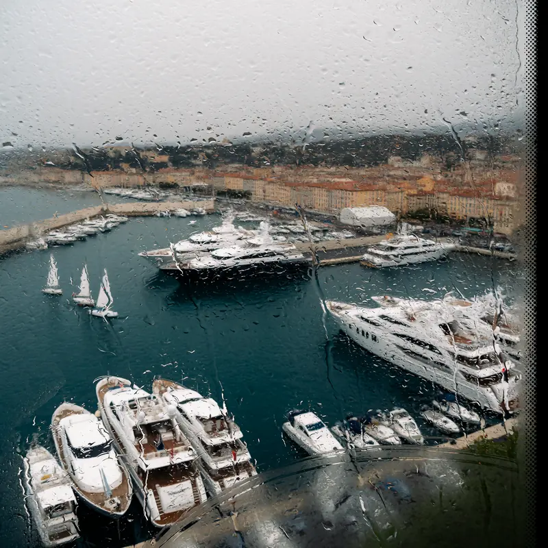 Krea 2 example: the port of antibes in the french riviera, large yachts and small sailboats are visible. rainy window style