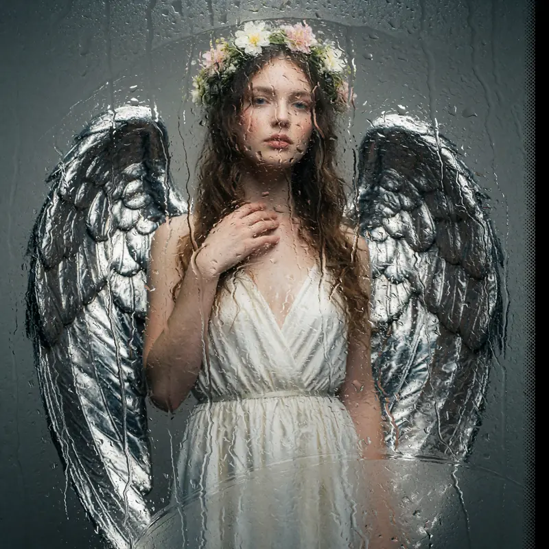 Krea 2 example: an angel with metallic wings and a crown of flowers. rainy window style