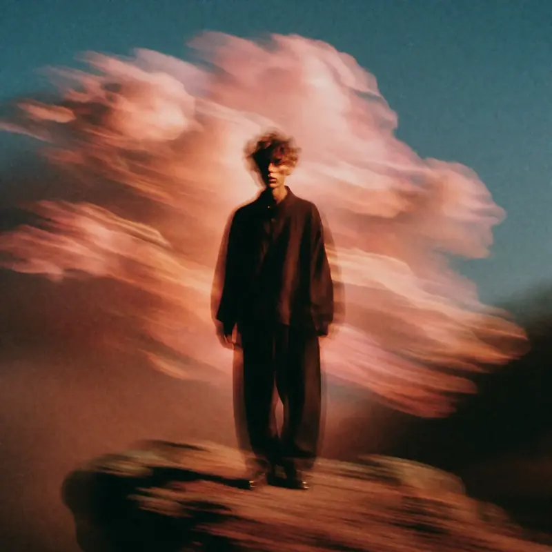 Krea 2 example: A solitary figure stands on a cliff, billowing clouds behind him. ethereal motion blur style