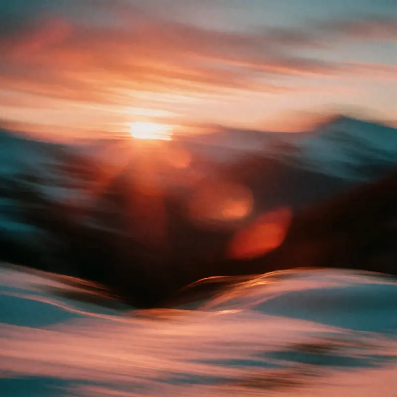 Krea 2 example: A sunset over snowy mountains. ethereal motion blur style