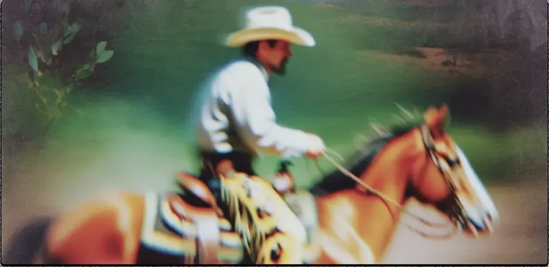 Krea 2 example: Male cowboy riding horse through the desert, close up shot